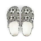 Kids gray EVA foam slip-on soccer clogs with soccer ball print, designed for comfort and playful style.